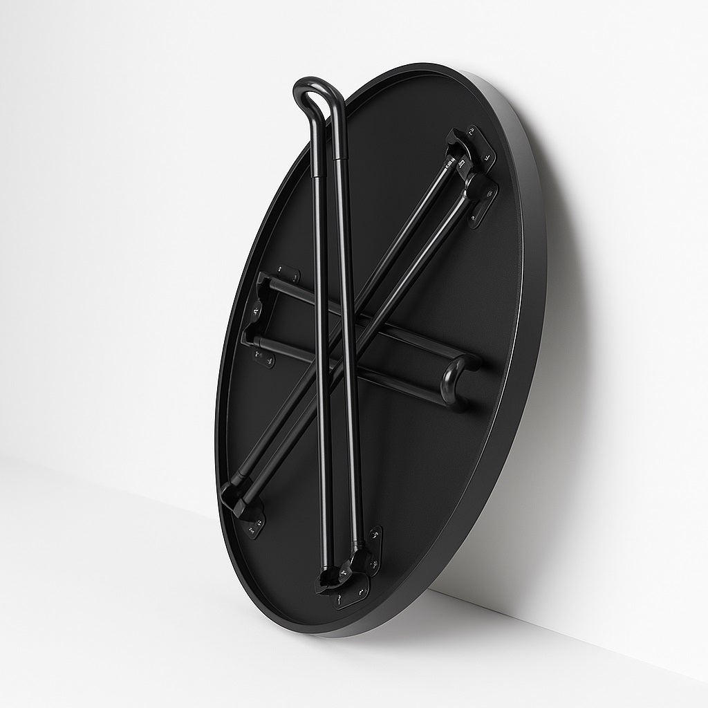 Pieds pliables en métal noir de la table basse ronde Arcus, structure robuste et pratique.